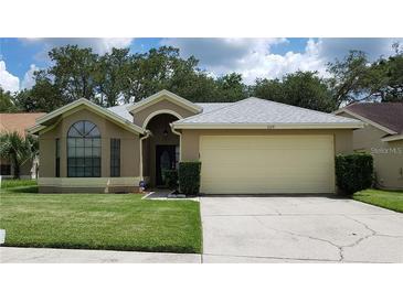 Charming single story home with a well maintained lawn, neutral colors, and a two car garage at 1524 Crawford Dr, Apopka, FL 32703