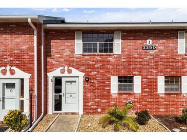 Charming brick condo featuring white trim, bright natural light, and well-maintained landscaping at 2250 S Palmetto Ave # I-11, Daytona Beach, FL 32119