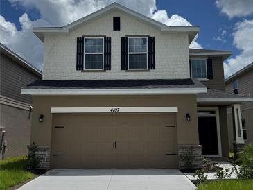 Charming two-story home showcasing a two-car garage and a well-maintained front yard at 4170 Sagefield Dr, Harmony, FL 34773
