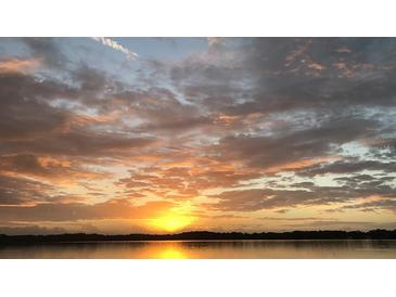 Scenic sunset view over the lake with clouds and reflections of orange and yellow light, Florida at 604 Desoto Dr, Casselberry, FL 32707