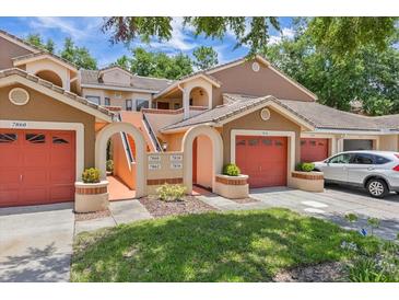 Charming multi-Gathering home featuring well-kept lawns and vibrant red garage doors at 7856 Sugar Bend Dr # 7856, Orlando, FL 32819