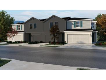 Charming townhome featuring a spacious garage, neutral exterior, and well-maintained landscaping at 16366 Bird Of Paradise Ave, Clermont, FL 34714