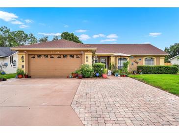 Charming single-story home with a well-maintained front yard, lush landscaping, and a spacious two-car garage at 1709 Kinsman Way, Lakeland, FL 33809