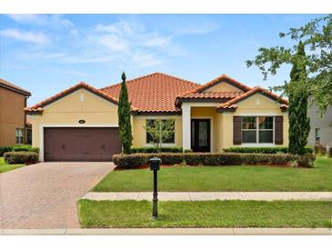 Charming single-story home featuring a well-manicured lawn and eye-catching red tile roof at 212 Lugano Way, Debary, FL 32713