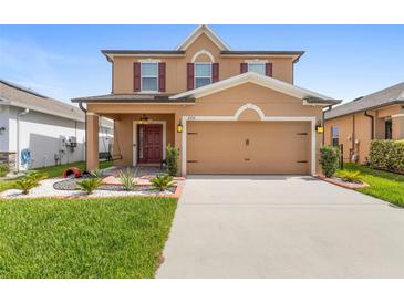 Charming two-story home features a well-manicured lawn, covered entry, and a spacious two-car garage at 2254 Canyon Breeze Ave, Kissimmee, FL 34746