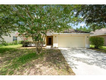 Charming single-story home with a well-maintained lawn, mature landscaping, and a two-car garage at 85 Levee Ln, Ormond Beach, FL 32174
