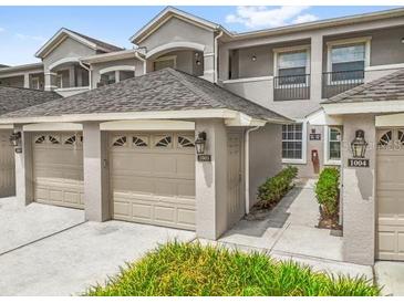 Charming townhome exterior featuring attached garages, neutral color palette, and well-maintained landscaping at 9440 Myrtle Creek Ln # 1003, Orlando, FL 32832