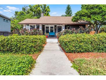 Charming bungalow featuring a well-manicured lawn, lush landscaping, and a welcoming front porch at 110 N Brown Ave, Orlando, FL 32801