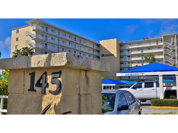 Harbor View condo exterior featuring a multi-story building with covered parking and views of the water at 145 N Halifax Ave # 705, Daytona Beach, FL 32118