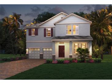 Charming two-story home with a well-maintained lawn, a two car garage, and attractive landscaping at 16158 Point Rock, Winter Garden, FL 34787