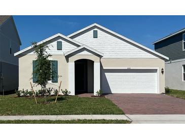 Charming single-story home with a two-car garage and a well-manicured front yard at 2043 Town Pasture Dr, Eustis, FL 32726