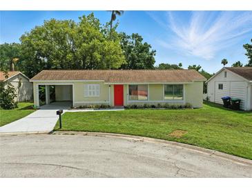 Attractive single-story home with an attached carport and a vibrant green lawn at 4825 Loretta Ln, Orlando, FL 32821