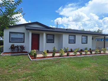 Charming single-story home with a well-maintained lawn and a bright red front door at 6366 Forecastle Ct, Orlando, FL 32807