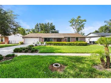 Charming single-story home with lush green lawn and well-manicured landscaping at 7022 Talbot Dr, Orlando, FL 32819
