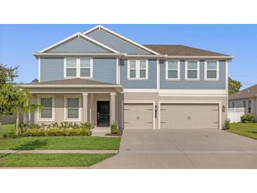 Charming two-story home with a well-manicured lawn and a spacious three-car garage at 9535 Beautiful Way, Winter Garden, FL 34787