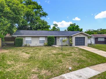 Charming single-story home featuring well-maintained landscaping and an attached garage at 117 Burns Ave, Longwood, FL 32750