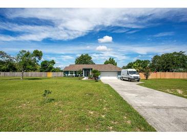 Charming single-story home boasts a well-manicured lawn, long driveway, and a bright, inviting exterior at 17927 E Apshawa Rd, Minneola, FL 34715