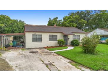 Charming single-story home featuring a brick exterior, well-maintained lawn, and covered parking at 3702 Starks St, Orlando, FL 32805