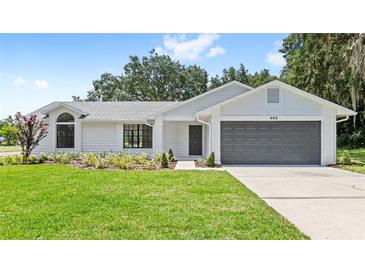 Charming single-story home with a well-manicured lawn, gray roof, and inviting curb appeal at 400 Timbercreek N Dr, Winter Garden, FL 34787