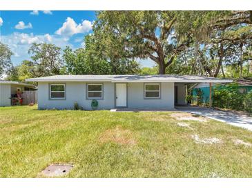Charming single-story home featuring a cozy carport and a well-maintained front lawn at 606 Washington St, Daytona Beach, FL 32114