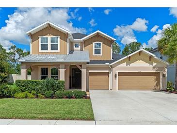 Beautiful two-story home featuring a manicured lawn, three-car garage, and tasteful curb appeal at 1224 Hillcrest View Loop, Apopka, FL 32703