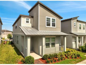 Charming two-story home featuring a modern design with neutral tones, well-maintained landscaping, and a welcoming front porch area at 172 S Zuni Rd, St Cloud, FL 34771