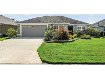 Well-maintained home featuring manicured landscaping and a neutral color palette at 2895 Apache Ct, The Villages, FL 32163