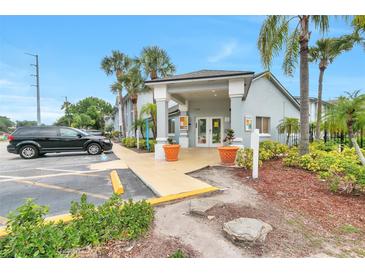 Inviting condominium entrance featuring well-manicured landscaping and ample parking at 4701 S Texas Ave # 4701A, Orlando, FL 32839