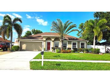 Charming single-story home features a well-maintained lawn and beautiful landscaping with palm trees at 4905 Newton Ct, St Cloud, FL 34771