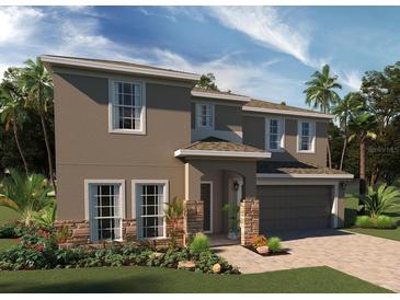 Two-story home showcasing a neutral stucco exterior, stone accents, and a paver driveway and walkway at 7986 Syracuse Dr, Clermont, FL 34714