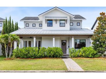 Charming two-story home with a manicured lawn and covered porch with decorative columns at 1410 W New Hampshire St, Orlando, FL 32804