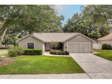 Charming single-story home with a well-manicured lawn and a two-car garage at 1073 Sadie Ln, Winter Garden, FL 34787