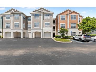 Condominium buildings boast well-maintained landscaping and convenient parking, perfect for easy access to your new home at 12843 Madison Pointe # 208, Orlando, FL 32821