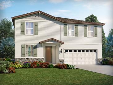 Charming two-story home featuring a two-car garage, stone accents and inviting front yard landscaping at 133 Archer Ave, Lake Alfred, FL 33850