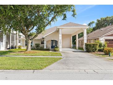 Charming single-story home featuring a covered carport, blue front door, and a well-maintained front yard at 16602 Citrus Pkwy, Clermont, FL 34714