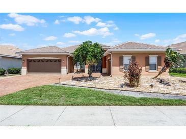 Charming single-story home with a well-manicured lawn, tiled roof, and a two-car garage at 3533 Somerset Cir, Kissimmee, FL 34746