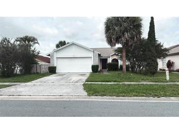 Charming single-story home with a well-maintained lawn and mature landscaping at 5265 Broken Arrow Dr, Kissimmee, FL 34746