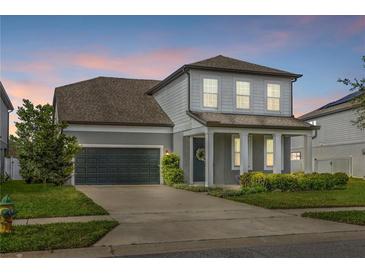 Charming two-story home with well-manicured lawn and inviting front porch with large garage at 840 Livestock Loop, St Cloud, FL 34771