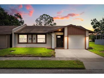 Charming single-story home with well-manicured lawn, neutral paint scheme, and attached one car garage at 999 Mancha Real Dr, Orlando, FL 32807