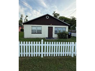 Modest home featuring a white picket fence and neutral color scheme at 1425 26Th St, Orlando, FL 32805