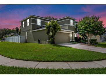 Charming two-story home with a well-manicured lawn and a paved driveway leading to an attached two-car garage at 2850 Spring Heather Pl, Oviedo, FL 32766