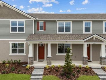 Charming townhome featuring a welcoming porch and well-maintained landscaping at 3279 Gardenia Reserve St, Apopka, FL 32712