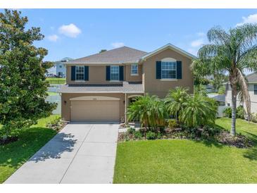Beautiful two-story home with lush landscaping, attached two-car garage, and inviting curb appeal at 352 Giovani Blvd, Clermont, FL 34715
