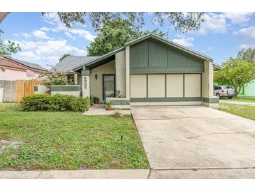 Charming single Gathering home featuring a well-maintained lawn and attached two car garage at 5308 Pinebury Ct, Orlando, FL 32808
