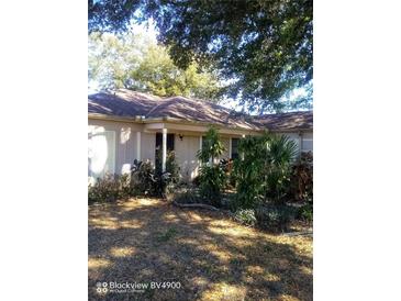 Charming single-story home featuring lush landscaping and mature trees at 2932 Silver Ridge Dr, Orlando, FL 32818