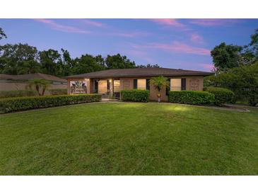 Charming home featuring a lush, manicured front lawn and mature landscaping, creating inviting curb appeal at 316 Amanda Ln, Leesburg, FL 34748