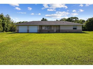 Charming one-story home with attached two-car garage and a spacious, well-maintained lawn at 3226 Midnight Star Ct, Kissimmee, FL 34744