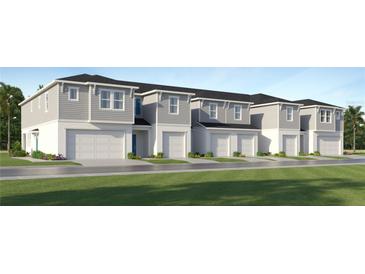 New construction townhomes featuring attached garages and modern exteriors at 349 Sol Vista Dr, Dundee, FL 33838