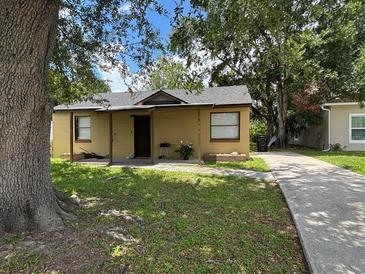Charming single-story home featuring a quaint front porch and well-maintained lawn at 4035 Nimons St, Orlando, FL 32811