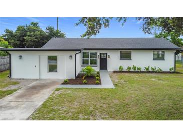 Charming single-story home featuring a freshly painted exterior, new landscaping, and a welcoming front entrance at 609 Brockway Ave, Orlando, FL 32807